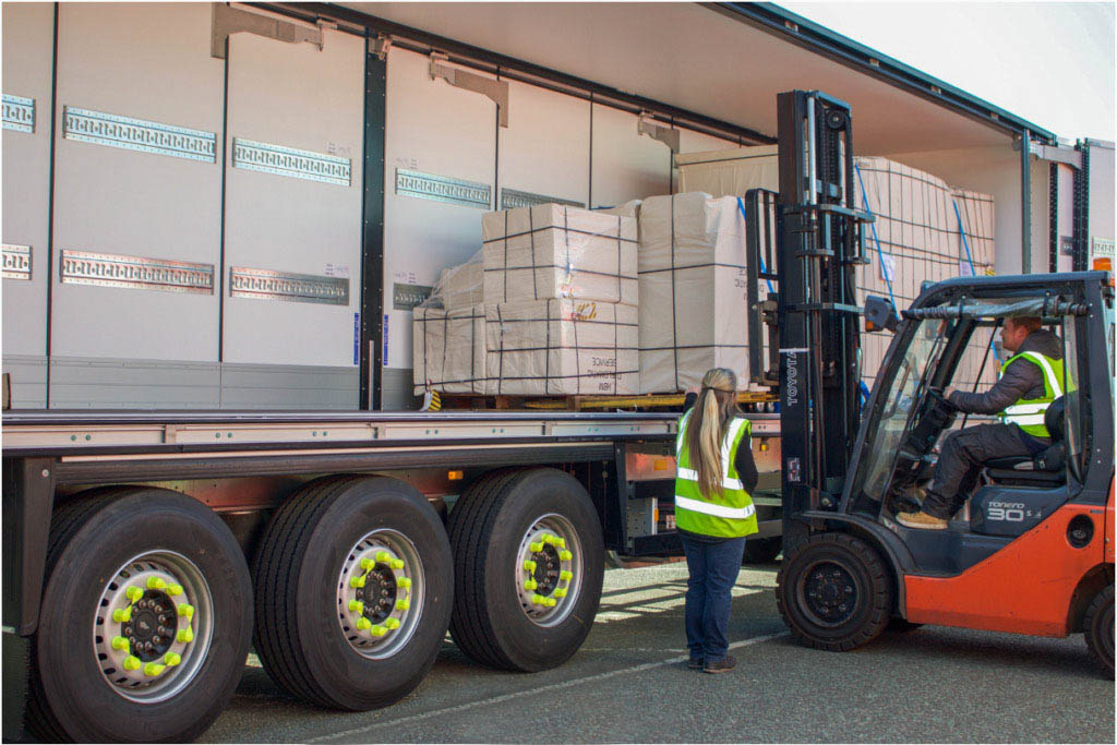 Lorry being loaded by fork truck with shipment of packaged vaccines